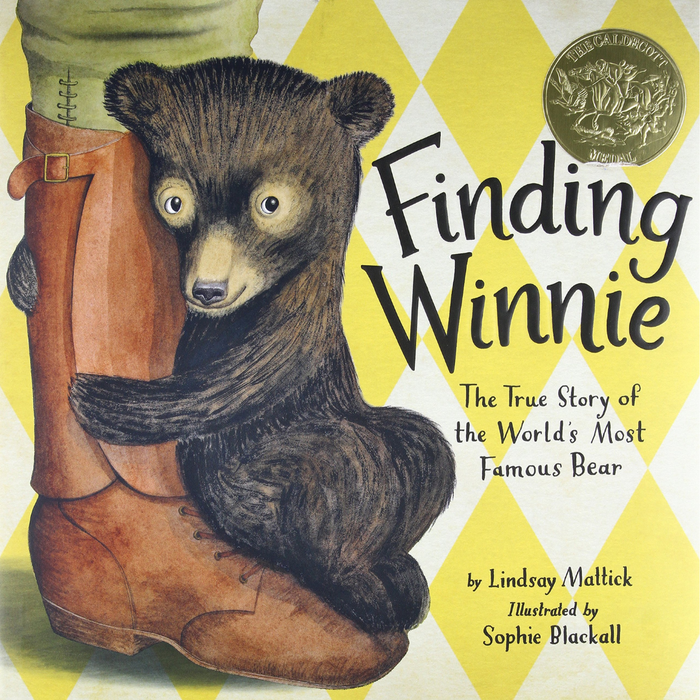 Book cover of Finding Winnie, featuring a bear cub hugging a boot. A gold Caldecott Medal in the top right corner honors this tale, inspired by Harry Colebourn.