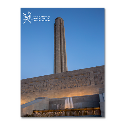 The image shows the Liberty Memorial tower at the National WWI Museum and Memorial, featuring a stone facade with carvings by WWI veteran Edmond Amateis and a fountain below, set against a clear blue sky.
