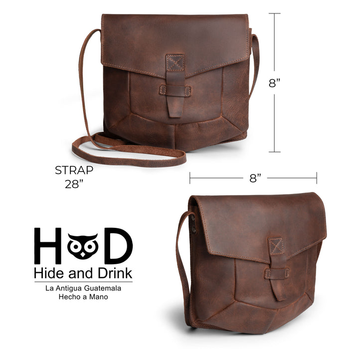 Dimensions illustration of the Prisma Shoulder Bag by Hide & Drink. This vintage purse offers practical sizing, making it an ideal messenger and crossbody bag. Crafted from full grain leather, this handmade product showcases the artisan techniques of being hand cut and hand sewn in La Antigua Guatemala & Oaxaca Mexico.