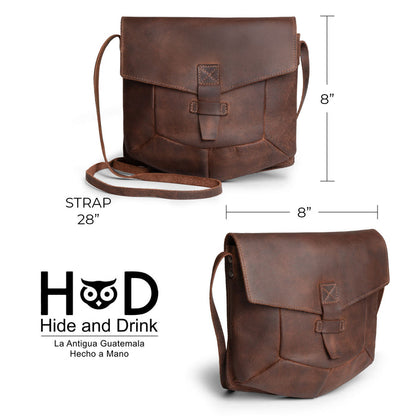 Dimensions illustration of the Prisma Shoulder Bag by Hide & Drink. This vintage purse offers practical sizing, making it an ideal messenger and crossbody bag. Crafted from full grain leather, this handmade product showcases the artisan techniques of being hand cut and hand sewn in La Antigua Guatemala & Oaxaca Mexico.